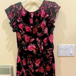 Pretty black peekaboo front solid on the back dress with flowers all over it.